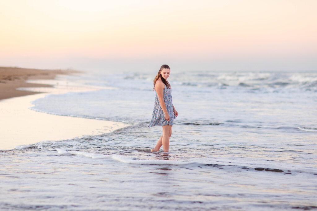 senior portrait girl in the ocean at sunset brooke tucker photography
