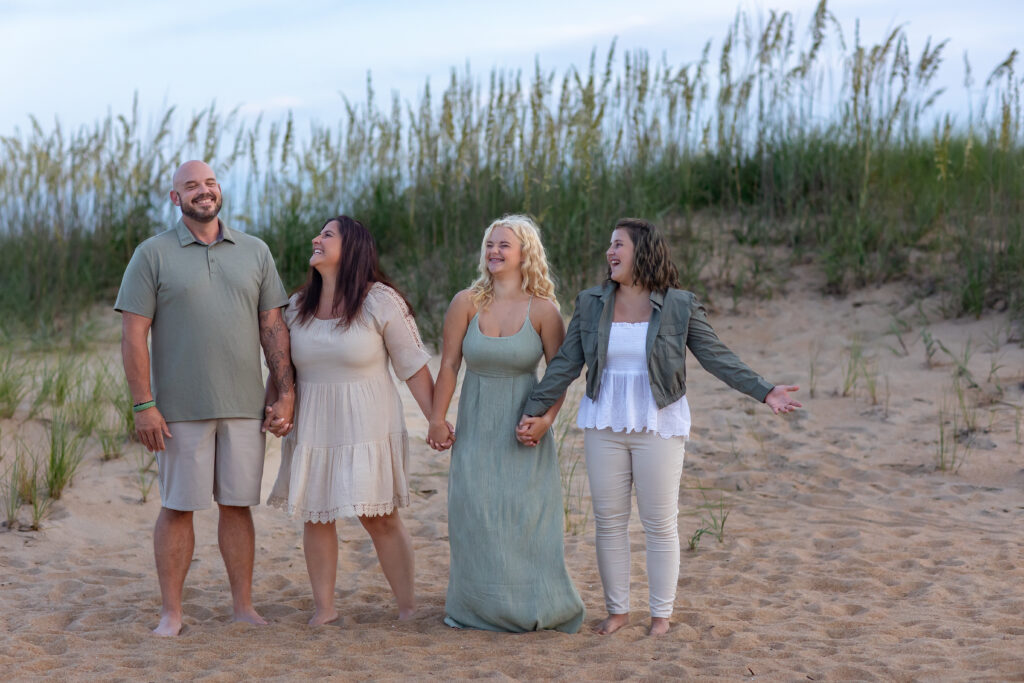family of four on the beach in virginia beach at sunset brooke tucker photography