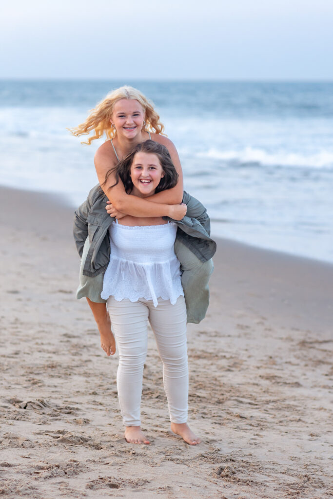 sisters by the ocean in virginia beach at sunset by brooke tucker photography
