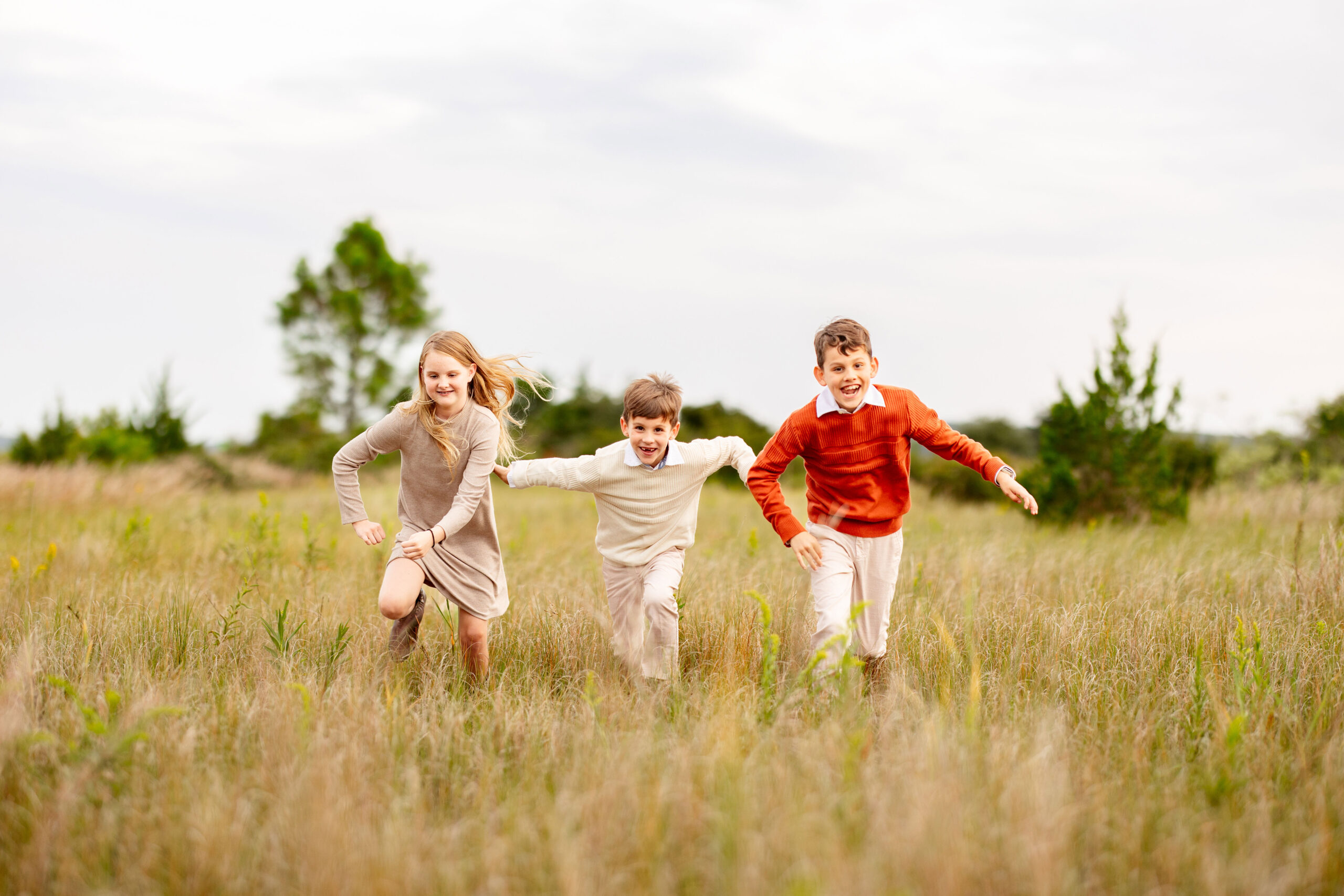 kids running in a field by brooke tucker photography