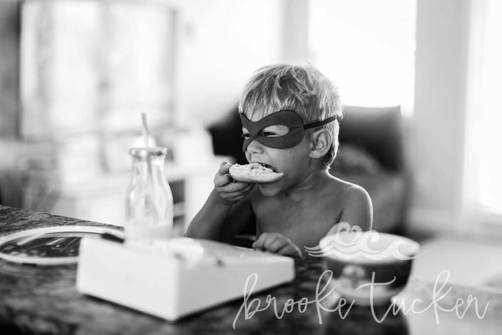 visual candid storytelling little superhero eating breakfast by brooke tucker photography